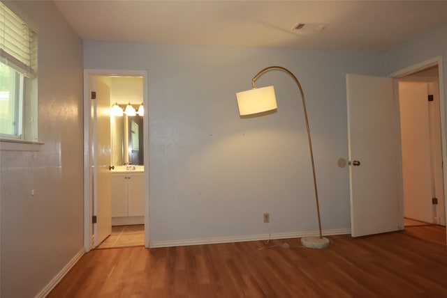 517 Annapolis Dr, Fort Worth, TX 76108 - unfurnished bedroom featuring wood finished floors and connected bathroom