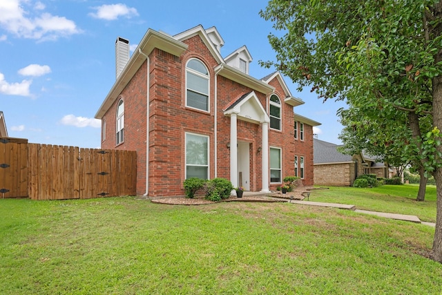 8534 Pebblebrook Dr, Frisco, TX 75034 - view of front of home with brick siding, a gate, and a chimney