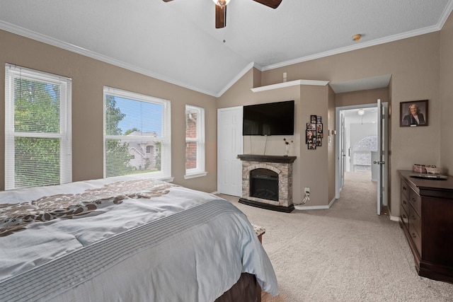 8534 Pebblebrook Dr, Frisco, TX 75034 - bedroom with light carpet, vaulted ceiling, crown molding, a stone fireplace, and a ceiling fan