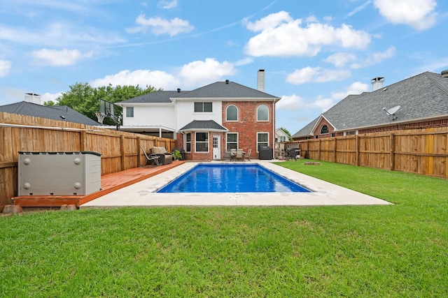 8534 Pebblebrook Dr, Frisco, TX 75034 - rear view of house featuring brick siding, a fenced backyard, a wooden deck, and a chimney