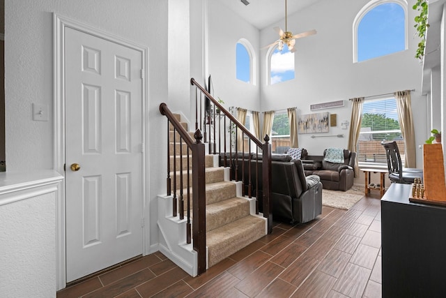 8534 Pebblebrook Dr, Frisco, TX 75034 - stairway featuring wood tiled floors, ceiling fan, and a high ceiling