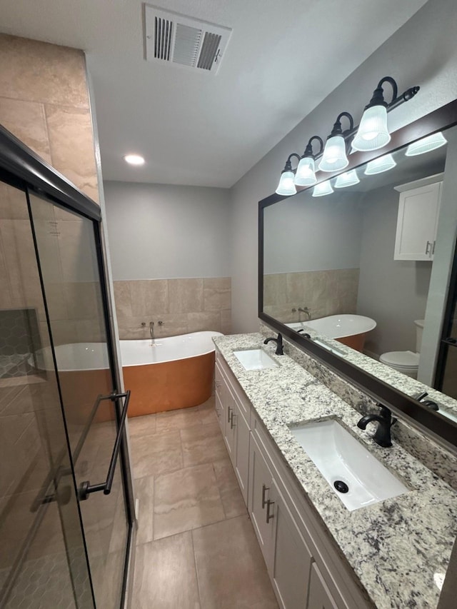 1510 W Woodard St, Denison, TX 75020 - full bath with a soaking tub, double vanity, a shower stall, and tile patterned flooring