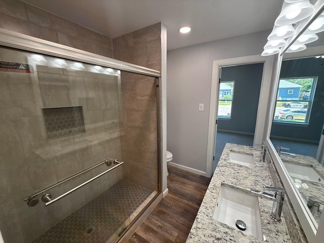1510 W Woodard St, Denison, TX 75020 - bathroom featuring wood finished floors, a stall shower, and double vanity