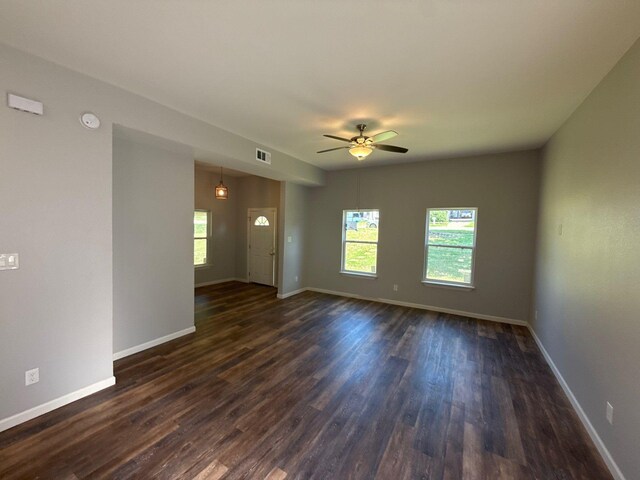 1510 W Woodard St, Denison, TX 75020 - unfurnished room featuring dark wood-type flooring, ceiling fan, and a smoke detector
