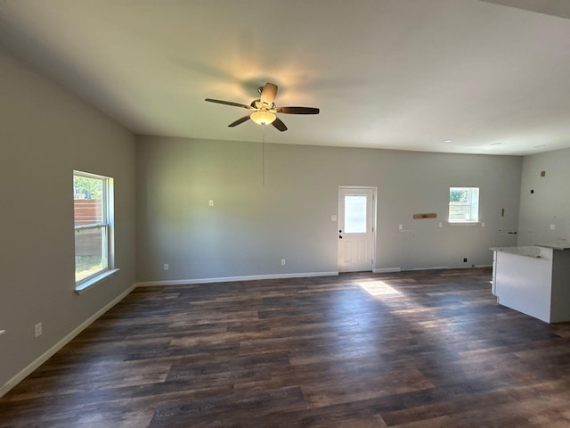 1510 W Woodard St, Denison, TX 75020 - unfurnished living room featuring healthy amount of natural light, a ceiling fan, and dark wood-type flooring