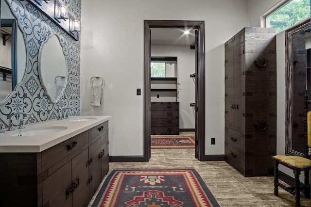 101 Goldfinch Ln, Weatherford, TX 76088 - bathroom featuring double vanity, plenty of natural light, wood finished floors, and a tile shower