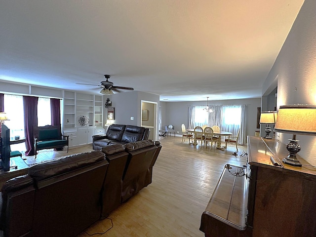 1325 W Chestnut St, Denison, TX 75020 - living room with light wood-style floors, ceiling fan, and a chandelier