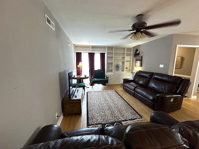 1325 W Chestnut St, Denison, TX 75020 - living area featuring light wood-type flooring, ceiling fan, and a textured wall