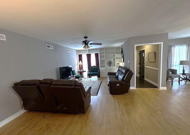 1325 W Chestnut St, Denison, TX 75020 - living area featuring light wood-style floors, plenty of natural light, and ceiling fan