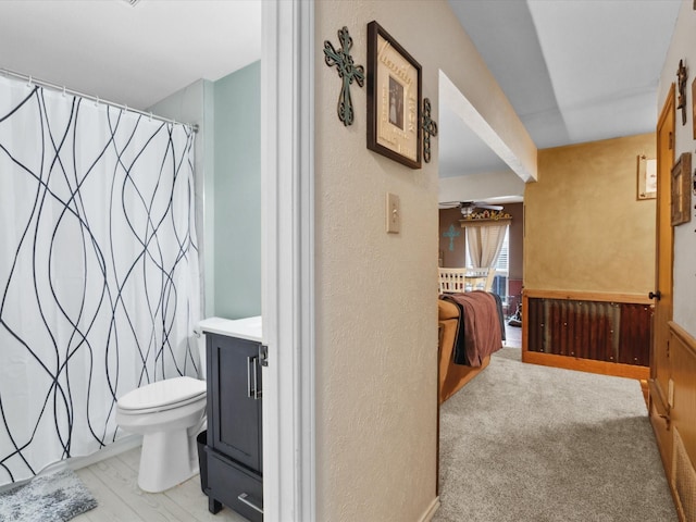 2012 Mobile Dr, Ennis, TX 75119 - bathroom featuring a shower with shower curtain, vanity, and a textured wall
