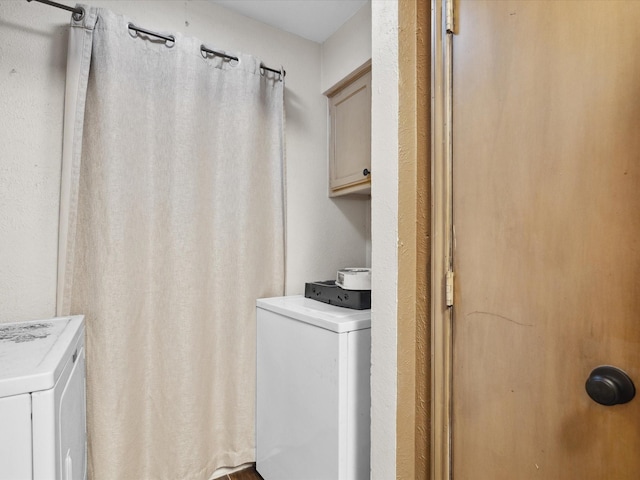 2012 Mobile Dr, Ennis, TX 75119 - laundry area with cabinet space and washing machine and clothes dryer