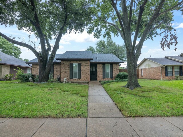 2012 Mobile Dr, Ennis, TX 75119 - single story home featuring brick siding, a front lawn, and roof with shingles
