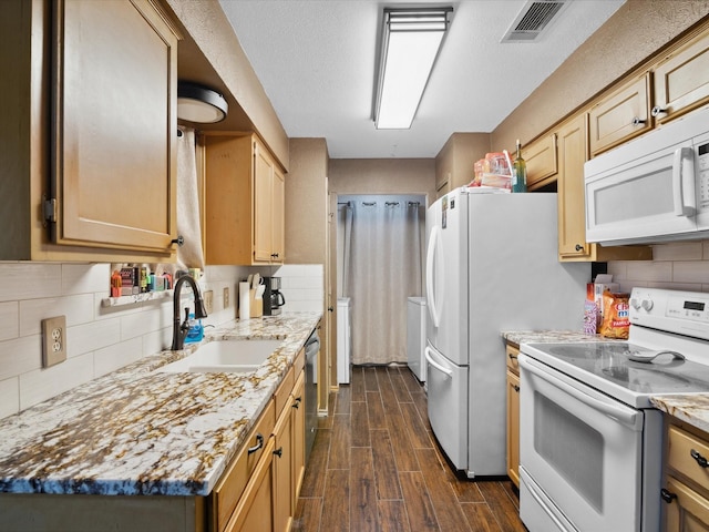 2012 Mobile Dr, Ennis, TX 75119 - kitchen featuring white appliances, dark wood-type flooring, tasteful backsplash, and light stone countertops