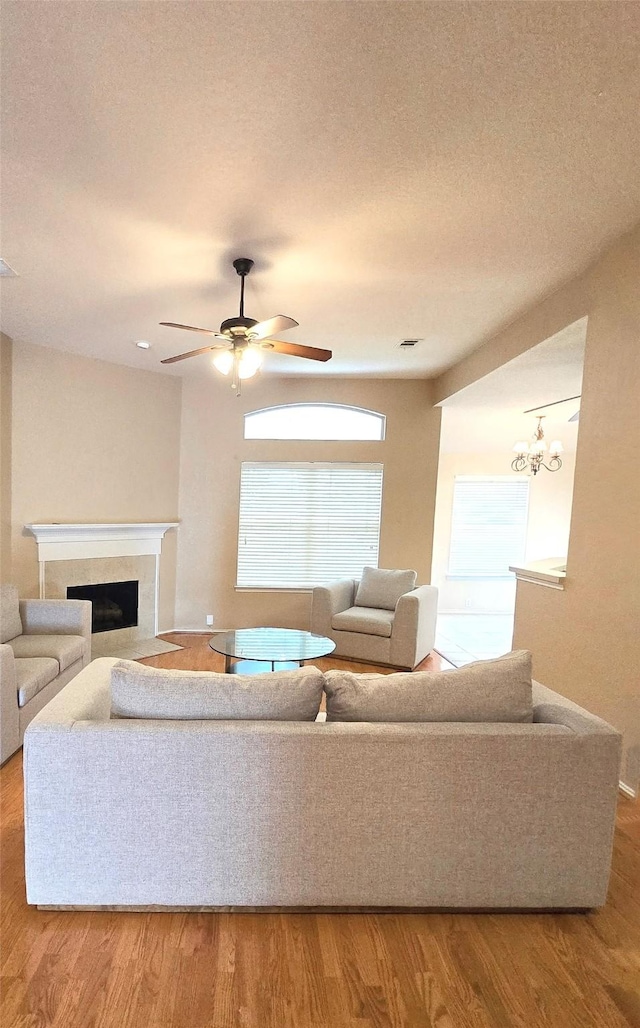 4012 Glenwyck Dr E, North Richland Hills, TX 76180 - living area with wood finished floors, a tile fireplace, and a ceiling fan