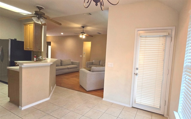 4012 Glenwyck Dr E, North Richland Hills, TX 76180 - kitchen with light tile patterned floors, a ceiling fan, freestanding refrigerator, a peninsula, and open floor plan