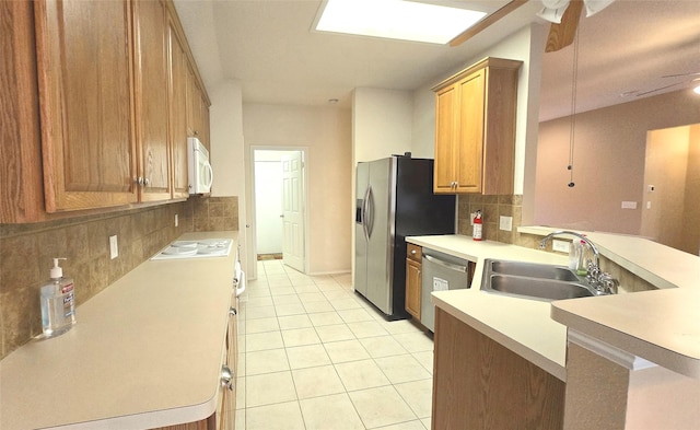 4012 Glenwyck Dr E, North Richland Hills, TX 76180 - kitchen with appliances with stainless steel finishes, decorative backsplash, light tile patterned floors, and a peninsula