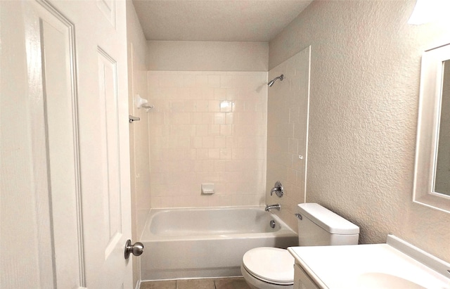 4012 Glenwyck Dr E, North Richland Hills, TX 76180 - bathroom featuring a textured wall, vanity, tub / shower combination, and tile patterned flooring
