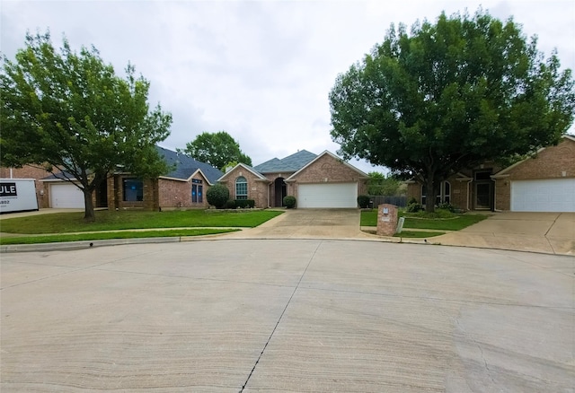 4012 Glenwyck Dr E, North Richland Hills, TX 76180 - view of front of house with driveway, a front yard, brick siding, and an attached garage