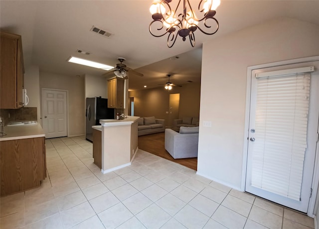 4012 Glenwyck Dr E, North Richland Hills, TX 76180 - kitchen featuring open floor plan, freestanding refrigerator, light countertops, a peninsula, and a ceiling fan