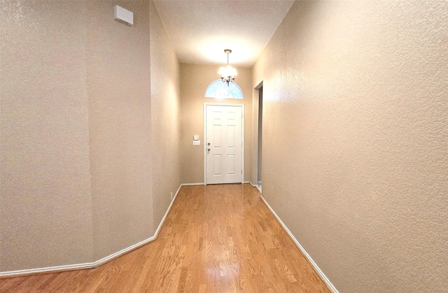 4012 Glenwyck Dr E, North Richland Hills, TX 76180 - doorway featuring light wood-style flooring, a textured wall, and a chandelier