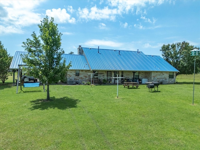 239 Valek Rd, Ennis, TX 75119 - rear view of property featuring a metal roof, a chimney, and a lawn