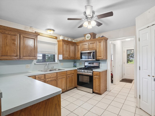 239 Valek Rd, Ennis, TX 75119 - kitchen with appliances with stainless steel finishes, light countertops, light tile patterned flooring, and ceiling fan