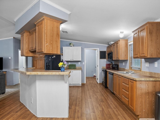 403 SE County Road 3048c, Corsicana, TX 75109 - kitchen featuring black appliances, light wood-type flooring, vaulted ceiling, crown molding, and light countertops