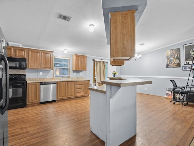 403 SE County Road 3048c, Corsicana, TX 75109 - kitchen with black appliances, light wood-style flooring, crown molding, and a peninsula
