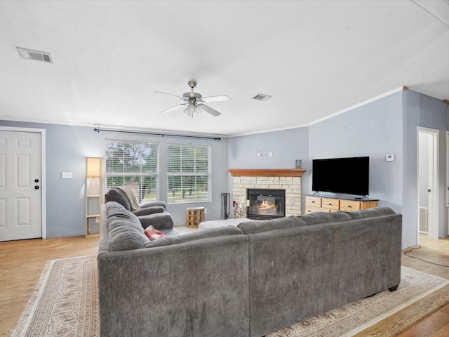 403 SE County Road 3048c, Corsicana, TX 75109 - living room featuring ceiling fan, crown molding, light wood-style floors, and a brick fireplace