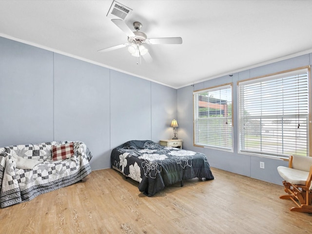403 SE County Road 3048c, Corsicana, TX 75109 - bedroom with crown molding, wood finished floors, a ceiling fan, and a decorative wall