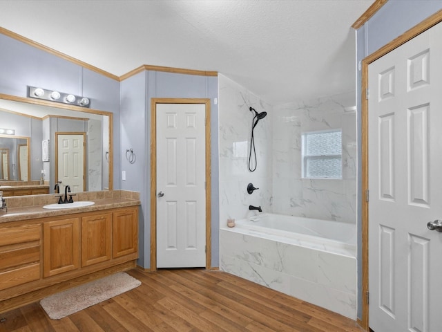 403 SE County Road 3048c, Corsicana, TX 75109 - bathroom featuring vanity, a combined bath / shower with marble appearance, wood finished floors, crown molding, and a textured ceiling