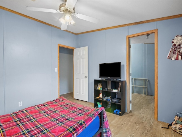403 SE County Road 3048c, Corsicana, TX 75109 - bedroom featuring crown molding, wood finished floors, and a ceiling fan