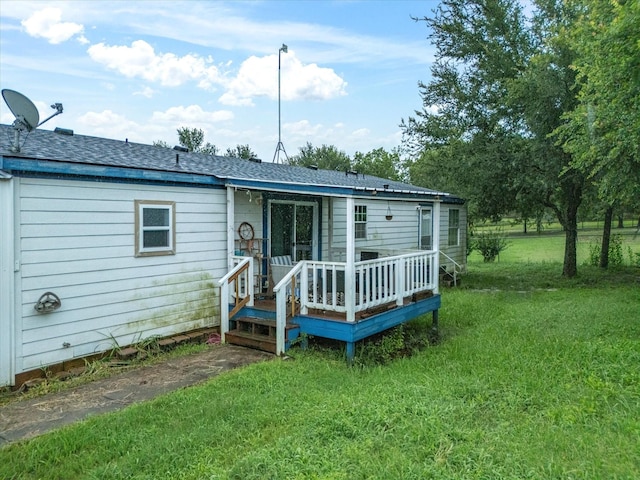 403 SE County Road 3048c, Corsicana, TX 75109 - back of house featuring a yard, a deck, and a shingled roof