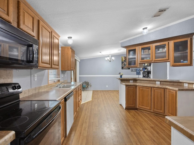 403 SE County Road 3048c, Corsicana, TX 75109 - kitchen with black appliances, brown cabinetry, a chandelier, a textured ceiling, and ornamental molding