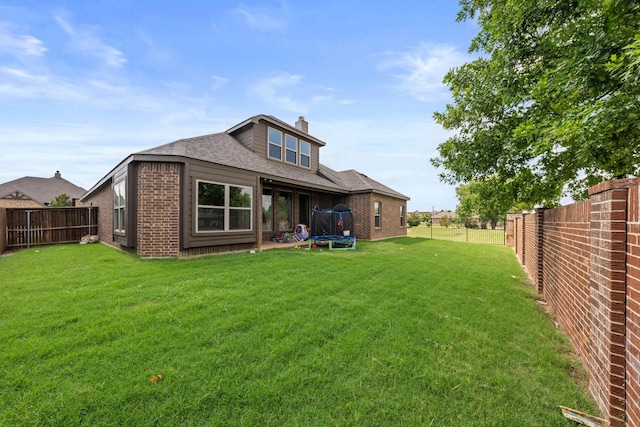406 Garden Tree Trl, Midlothian, TX 76065 - rear view of property featuring a trampoline, brick siding, a fenced backyard, and a chimney