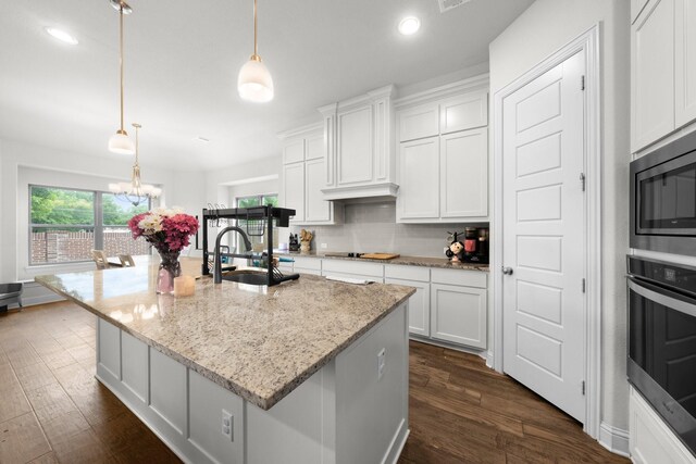406 Garden Tree Trl, Midlothian, TX 76065 - kitchen featuring stainless steel appliances, dark wood-type flooring, white cabinetry, a chandelier, and recessed lighting