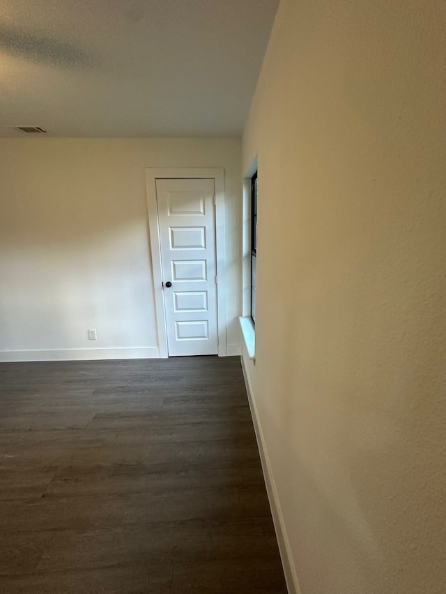 616 Leyenda Dr, Mesquite, TX 75149 - unfurnished room featuring baseboards and dark wood finished floors
