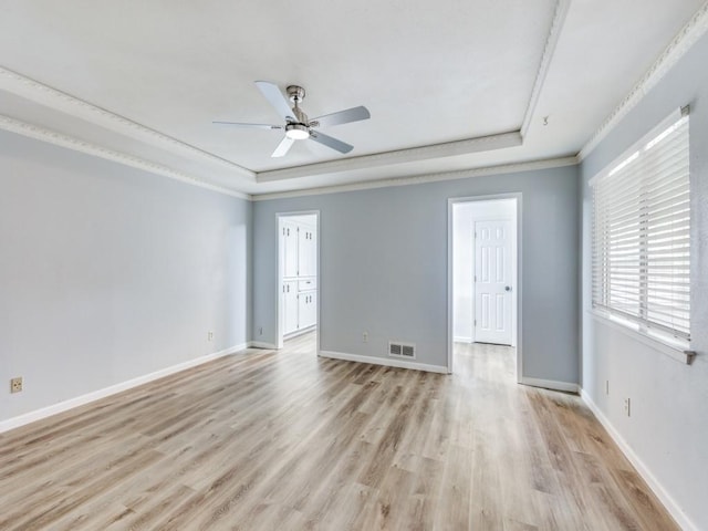 810 Serenade Ln, Richardson, TX 75081 - spare room with a raised ceiling, light wood-style flooring, a ceiling fan, and crown molding