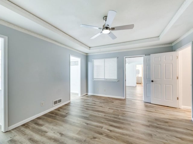 810 Serenade Ln, Richardson, TX 75081 - spare room with a raised ceiling, light wood finished floors, a ceiling fan, and crown molding