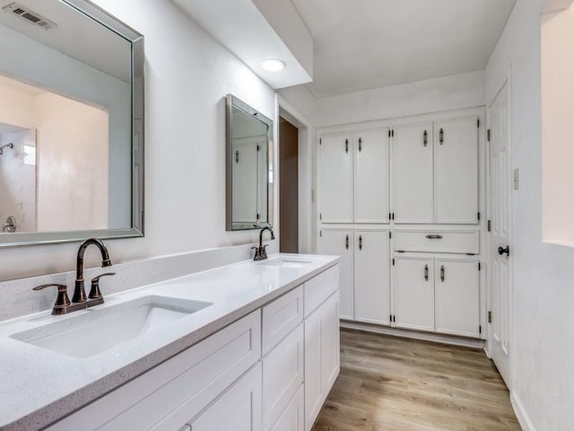 810 Serenade Ln, Richardson, TX 75081 - full bathroom with double vanity and wood finished floors