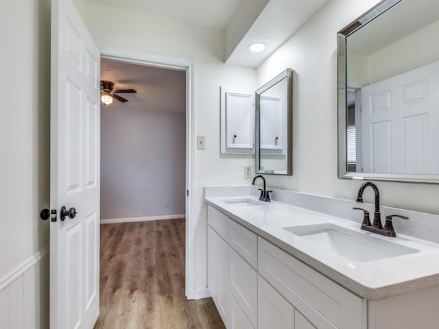 810 Serenade Ln, Richardson, TX 75081 - full bath with double vanity, wood finished floors, and a ceiling fan