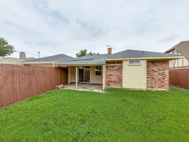 810 Serenade Ln, Richardson, TX 75081 - rear view of property with a fenced backyard, a chimney, a shingled roof, brick siding, and a patio area