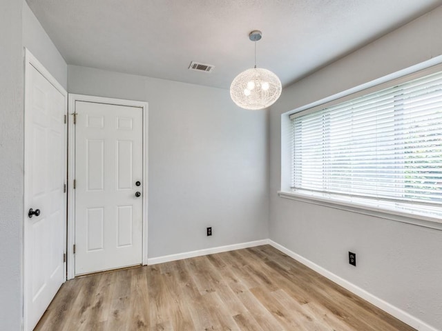 810 Serenade Ln, Richardson, TX 75081 - empty room featuring light wood-type flooring and a chandelier