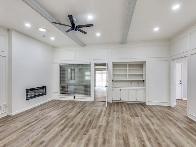 810 Serenade Ln, Richardson, TX 75081 - unfurnished living room with light wood-type flooring, beam ceiling, recessed lighting, ceiling fan, and a decorative wall