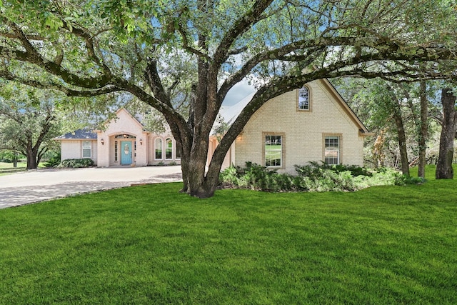 8502 Linden Ct, Granbury, TX 76049 - view of front of home with brick siding, driveway, and a front yard