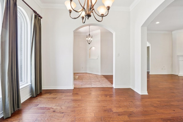 8502 Linden Ct, Granbury, TX 76049 - spare room with a chandelier, wood-type flooring, arched walkways, ornamental molding, and recessed lighting