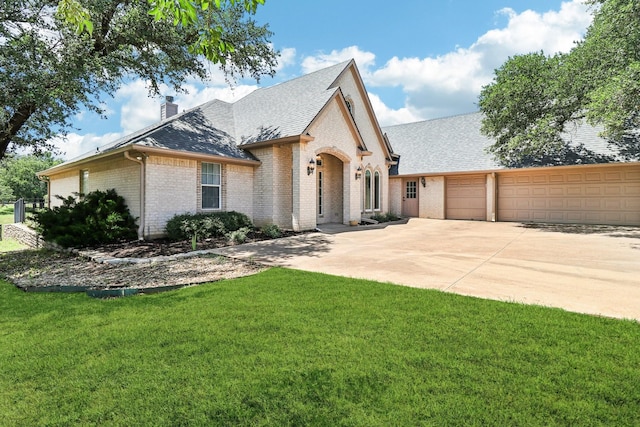 8502 Linden Ct, Granbury, TX 76049 - french provincial home featuring brick siding, a shingled roof, concrete driveway, a chimney, and an attached garage