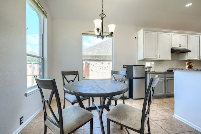 2860 Prado, Grand Prairie, TX 75054 - dining room with a chandelier, light tile patterned floors, and a textured wall