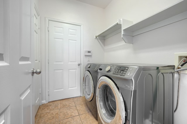 2860 Prado, Grand Prairie, TX 75054 - laundry area featuring washing machine and clothes dryer and light tile patterned floors