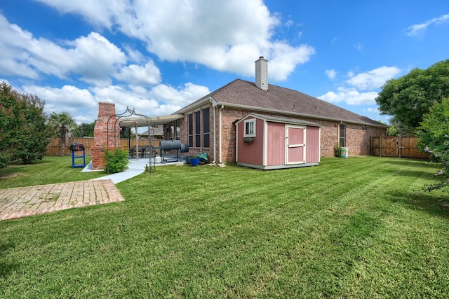 2860 Prado, Grand Prairie, TX 75054 - rear view of house featuring a patio, brick siding, a storage unit, a chimney, and a fenced backyard